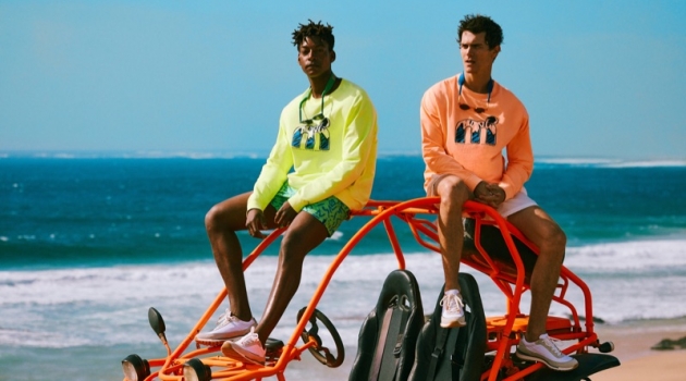 Mango Brings Back 90s Style with Mistral Collaboration Taking to the beach, Ty Ogunkoya and Vincent LaCrocq sport highlighter-colored tees and swim shorts from Mango's Mistral collaboration.