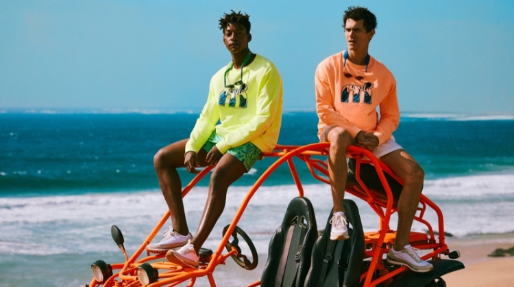 Taking to the beach, Ty Ogunkoya and Vincent LaCrocq sport highlighter-colored tees and swim shorts from Mango's Mistral collaboration.