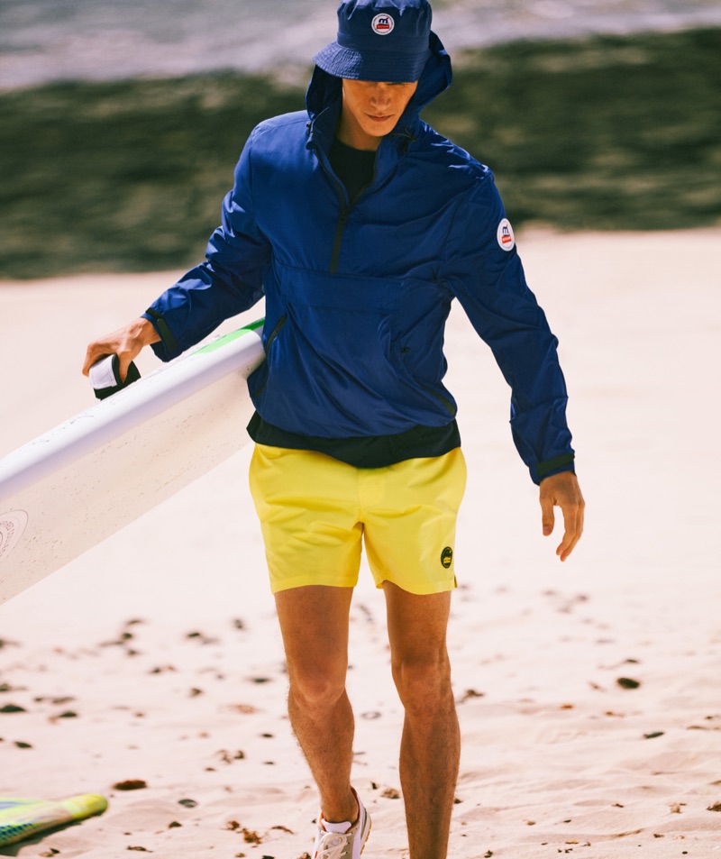 Going sporty, Vincent LaCrocq rocks a windbreaker, bucket hat, and shorts from Mango's Mistral collaboration.