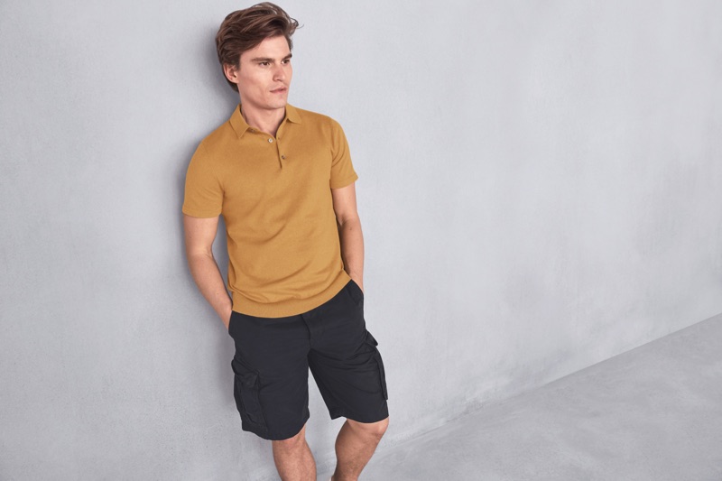 A smart vision, Oliver Cheshire wears a polo shirt and cargo shorts from Marks & Spencer.