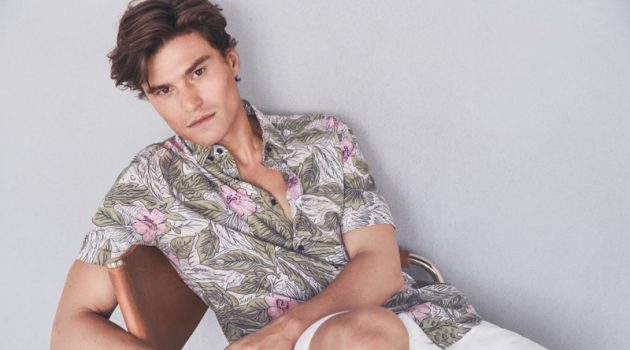 Reuniting with Marks & Spencer, Oliver Cheshire dons a printed shirt with white shorts from Marks & Spencer.