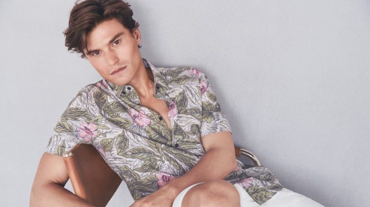 Reuniting with Marks & Spencer, Oliver Cheshire dons a printed shirt with white shorts from Marks & Spencer.