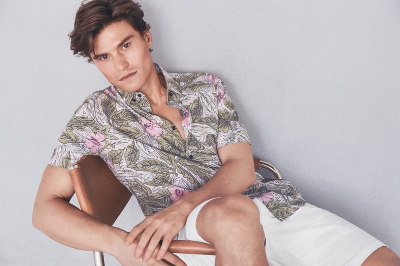 Reuniting with Marks & Spencer, Oliver Cheshire dons a printed shirt with white shorts from Marks & Spencer.