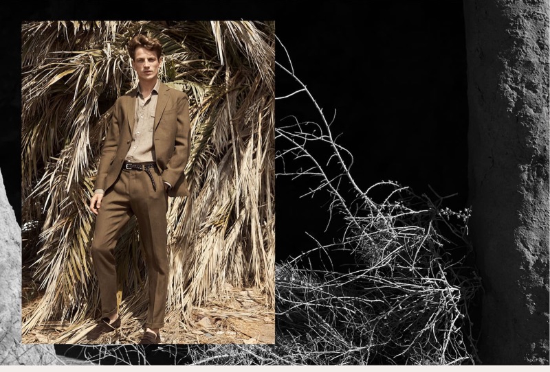 Donning a brown suit, Hugo Sauzay wears Massimo Dutti.