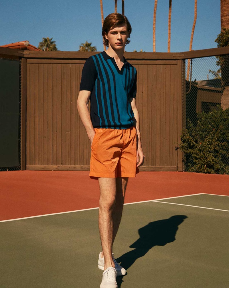 Embracing a retro attiude, Efraim Schröder wears an Orlebar Brown polo shirt with Everest Isles shorts and Givenchy sneakers.