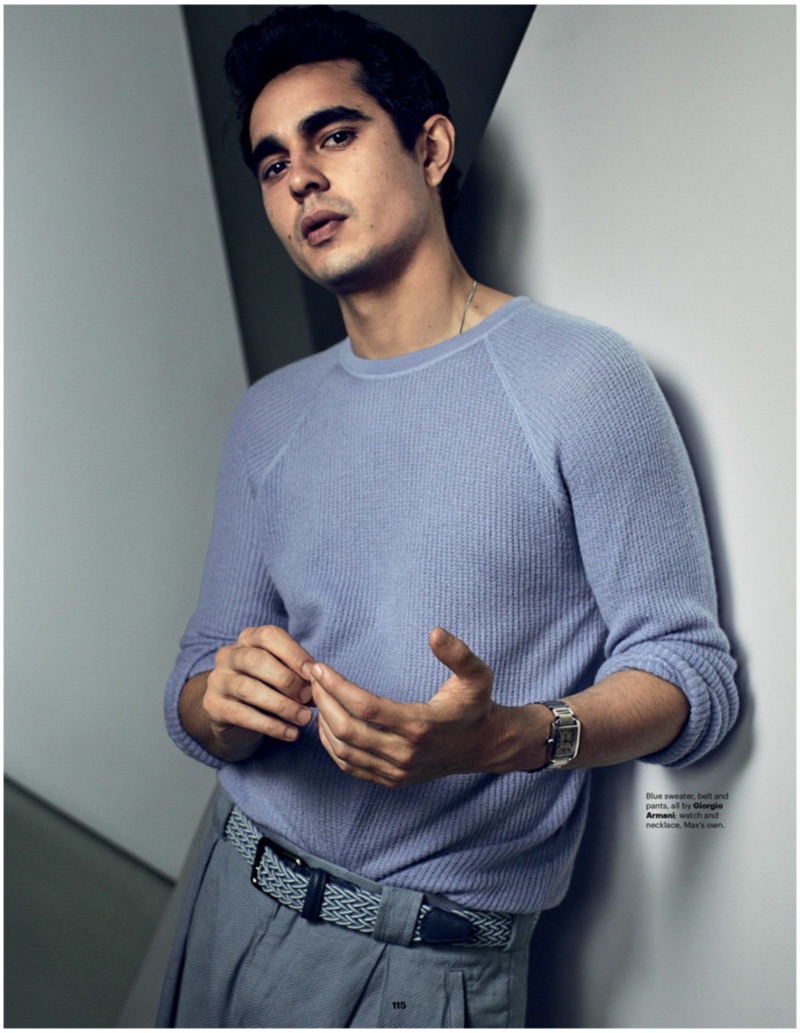 A chic vision, Max Minghella dons a sweater, belt, and pants by Giorgio Armani.