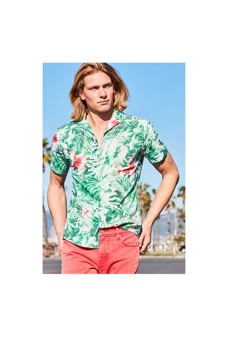 Hunter Bach sports a green Michael Kors slim-fit jungle-print camp shirt $98.