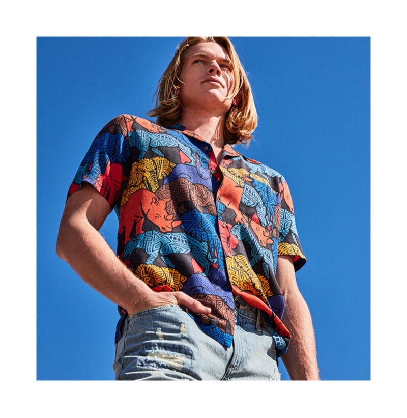 Embracing a colorful print, Hunter Bach models a Tasso Elba Congo graphic camp collar silk shirt $65.