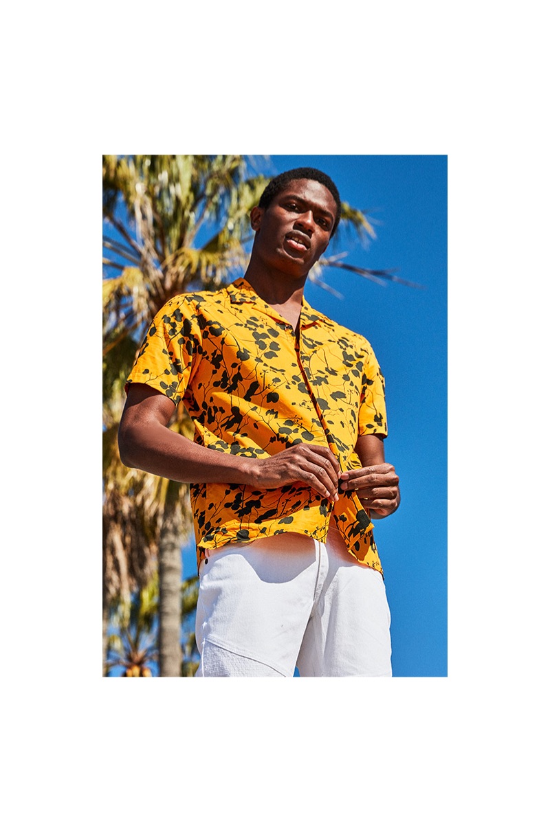 Standing out in yellow, Hamid Onifade dons an I.N.C. men's twig leaf camp collar shirt $55.