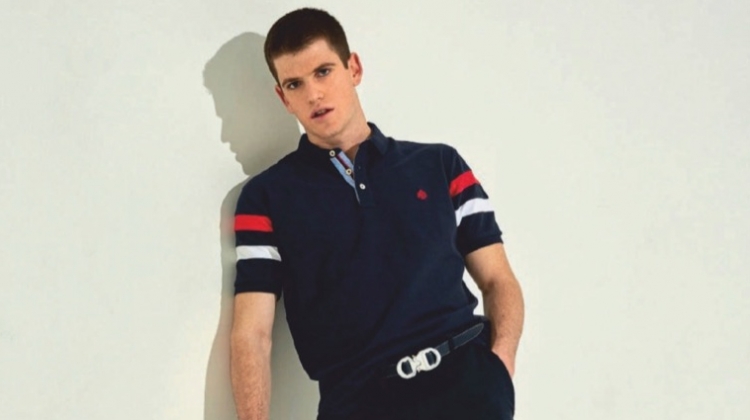 Striking a pose, Miguel Bernardeau wears a Springfield polo with a belt and pants by Dior Men. He also sports Calvin Klein Jeans shoes.