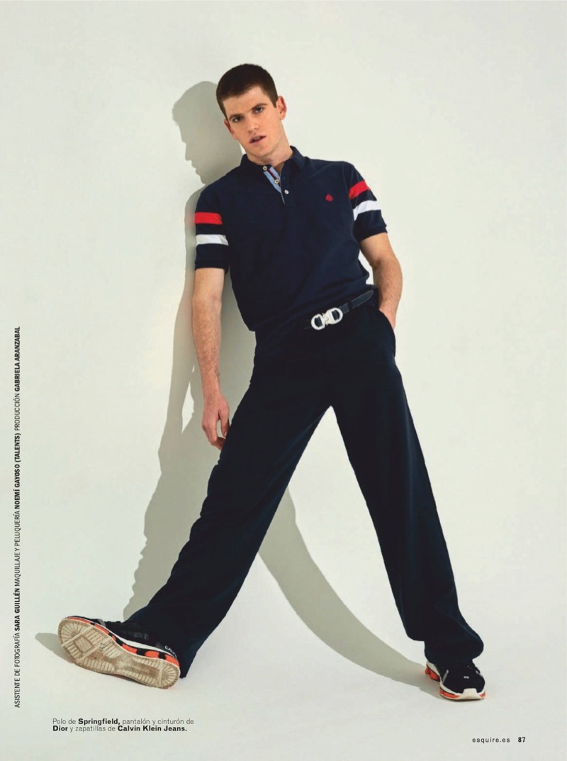 Striking a pose, Miguel Bernardeau wears a Springfield polo with a belt and pants by Dior Men. He also sports Calvin Klein Jeans shoes.