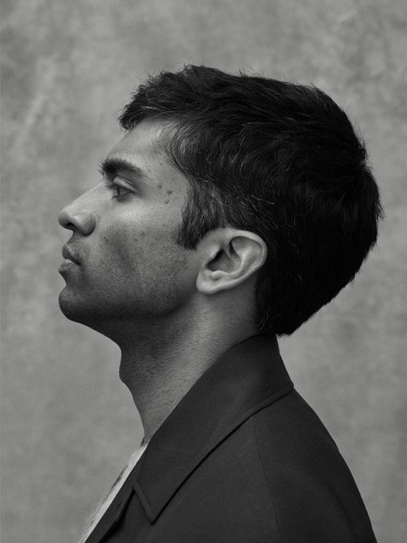 Delivering a side profile, Nikesh Patel rocks a Prada coat with a Beams Plus mélange mohair-blend sweater.