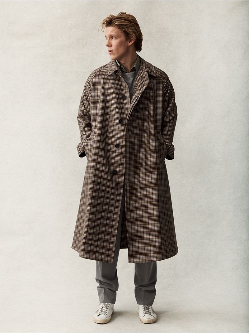 Actor Freddie Wise dons an oversized Stella McCartney checked coat, Theory shirt, John Elliott t-shirt, Golden Goose Superstar sneakers, and wool trousers by The Row.