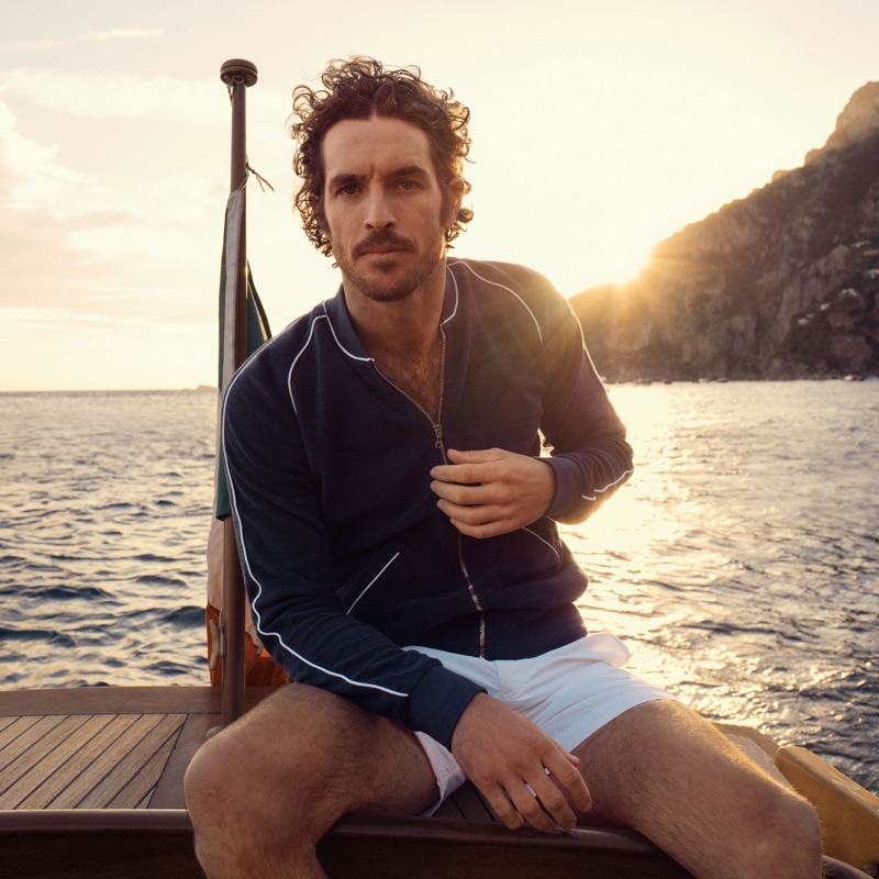 Embracing a moment of leisure, Justice Joslin sports Orlebar Brown's 007 A View to Kill piped toweling jacket $475.