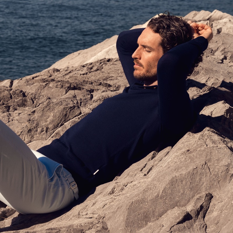 Relaxing, Justice Joslin sports a navy Thunderball polo $475 from Orlebar Brown's 007 collection.