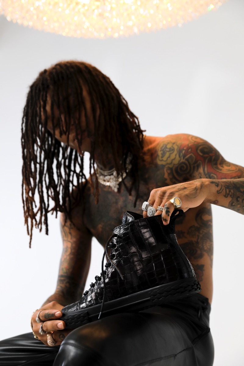 Swae Lee poses with Giuseppe Zanotti's black Blabber hi-top sneakers.