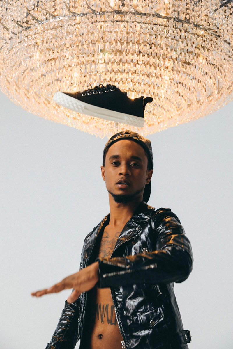 Rocking a leather biker jacket, Slim Jxmmi is pictured with Giuseppe Zanotti's black Blabber sneakers.