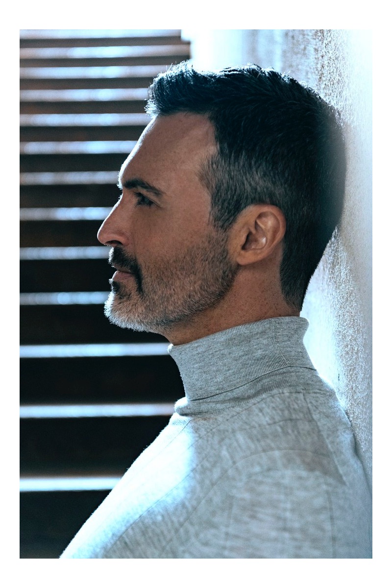 Delivering a side profile, Reid Scott wears a turtleneck from his own wardrobe.