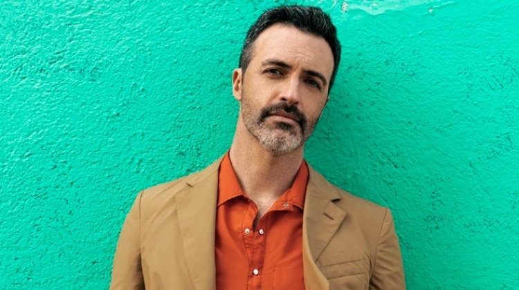 Front and center, Reid Scott wears a shirt and suit by Salvatore Ferragamo.