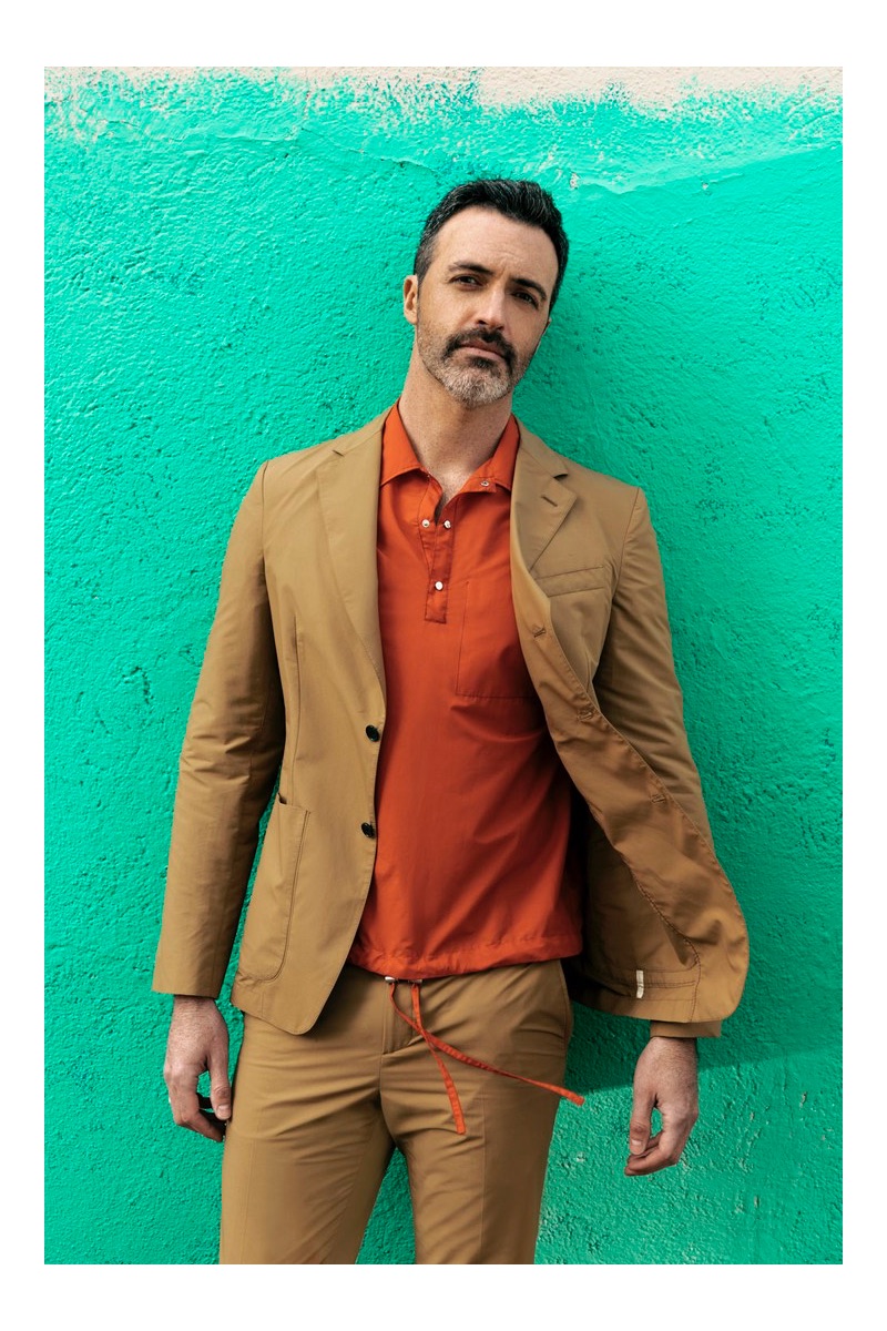 Front and center, Reid Scott wears a shirt and suit by Salvatore Ferragamo.