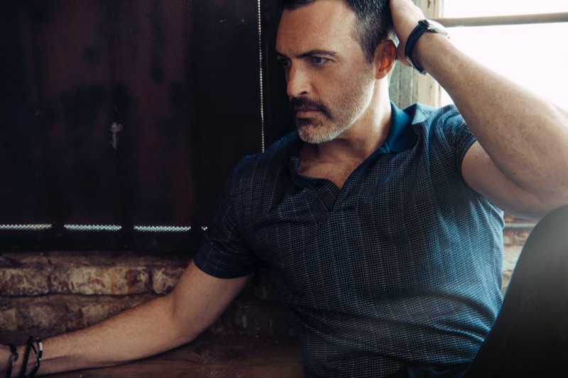 A smart vision, Reid Scott wears an Ermenegildo Zegna shirt, AllSaints pants, and a Cartier watch.