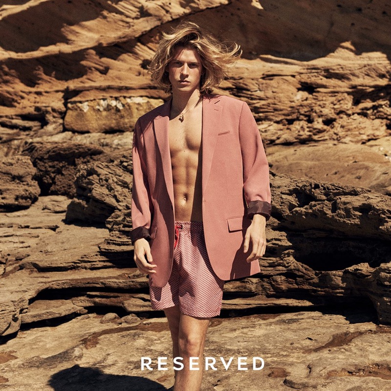 Wearing an oversized jacket, Biel Juste also sports swim shorts by Reserved.