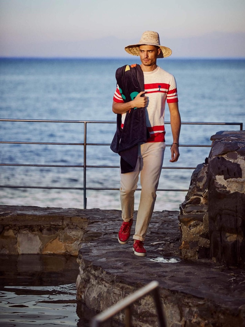 Going for a walk, Ivan Kozak sports a Scotch & Soda Placement red stripe t-shirt $125 with cotton-linen trousers $148.