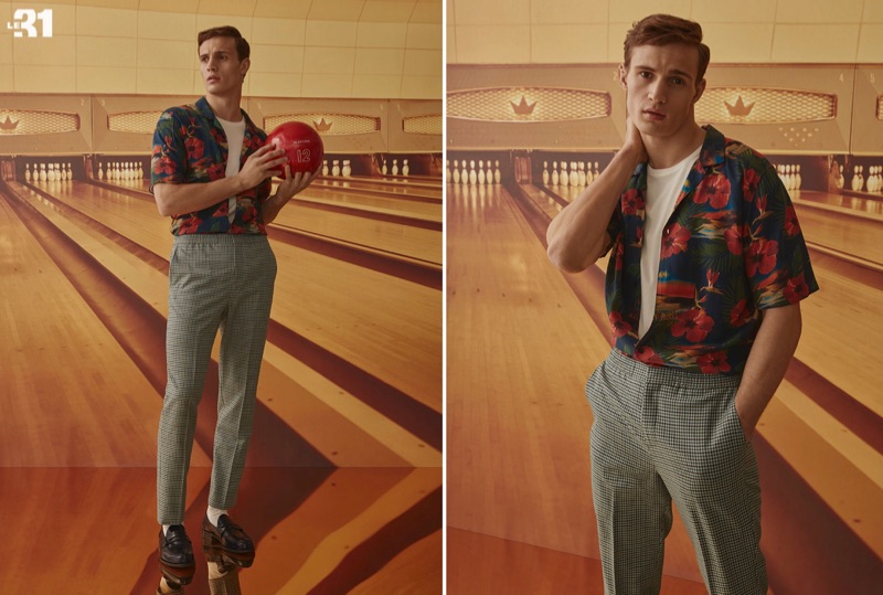 Model Julian Schneyder wears an island flower print shirt and gingham jogger pants by LE 31.