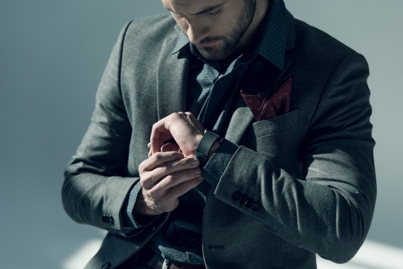 Stylish Man in Suit Checking Watch