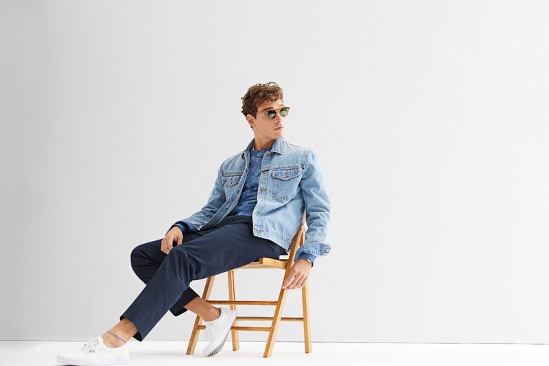 Casually chic, Alexandre Cunha models a Todd Snyder Japanese stretch selvedge denim jacket $288 in stone wash with a + Champion tie-dye sweatshirt $148 in blue grotto and navy pants.