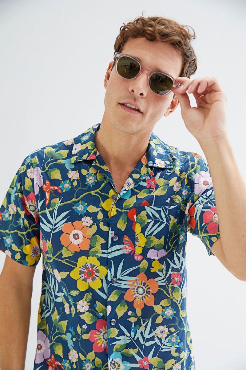 Embracing summer style, Alexandre Cunha rocks a Todd Snyder Liberty camp collar tropical print shirt $158 in blue.