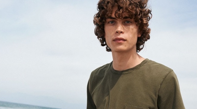 Life's a Beach: Lucas Bin Goes Casual in Summer Style for YOOX Hitting the beach, Lucas Bin sports military green Dries Van Noten swim shorts $244.