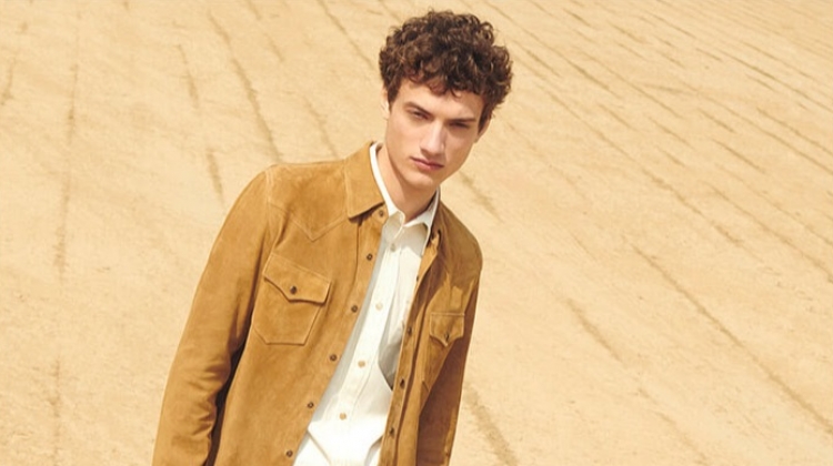 Serge Rigvava embraces western style in a suede overshirt with a Calvin Klein shirt, Gucci jeans, and suede ankle boots.