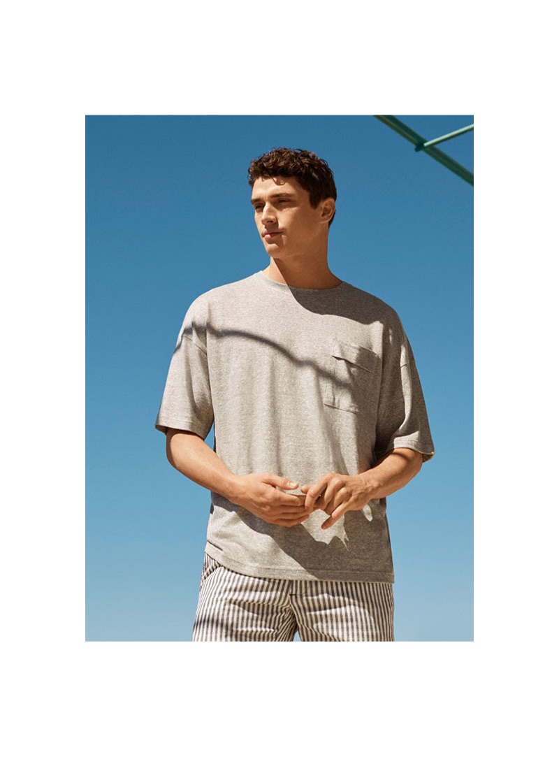 Going casual, Matthew Holt models a 8 by YOOX t-shirt $39 and striped Bermuda shorts $74.