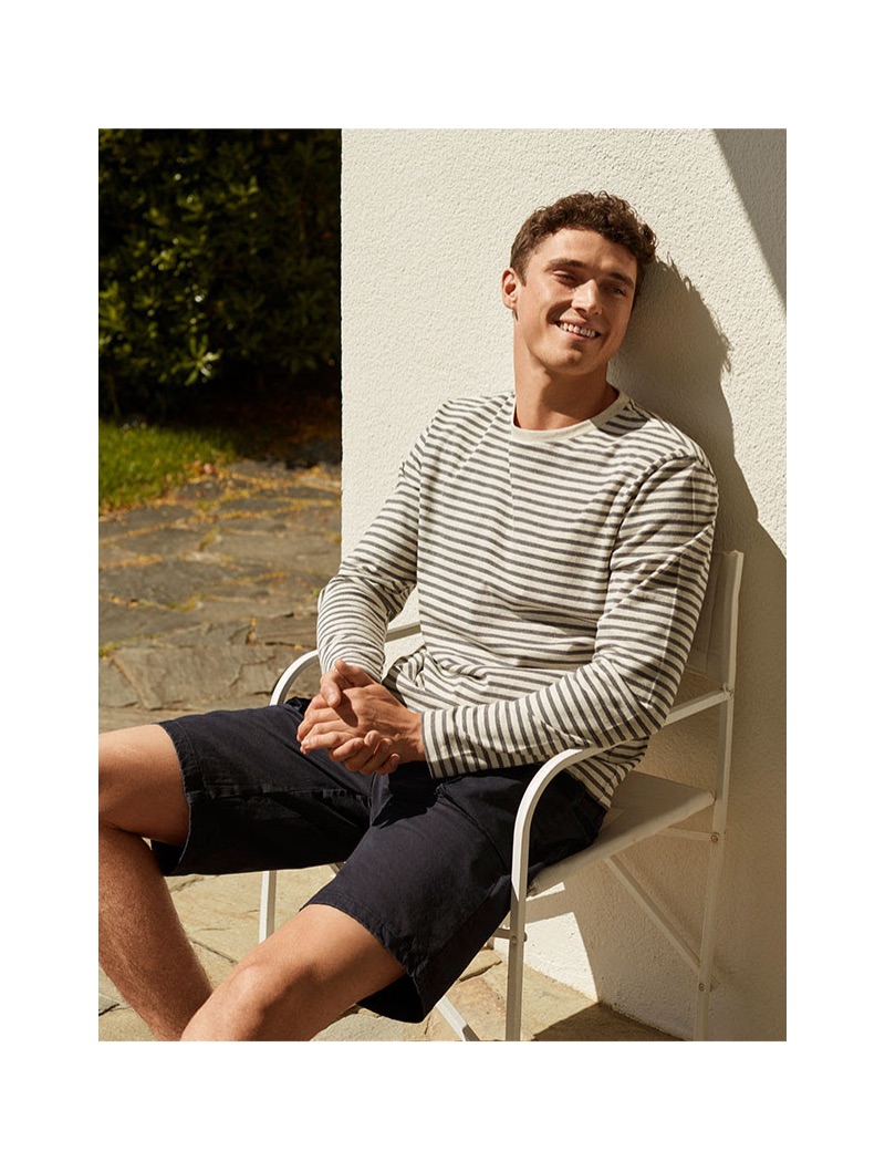 All smiles, British model Matthew Holt dons a striped pullover and denim shorts from 8 by YOOX.