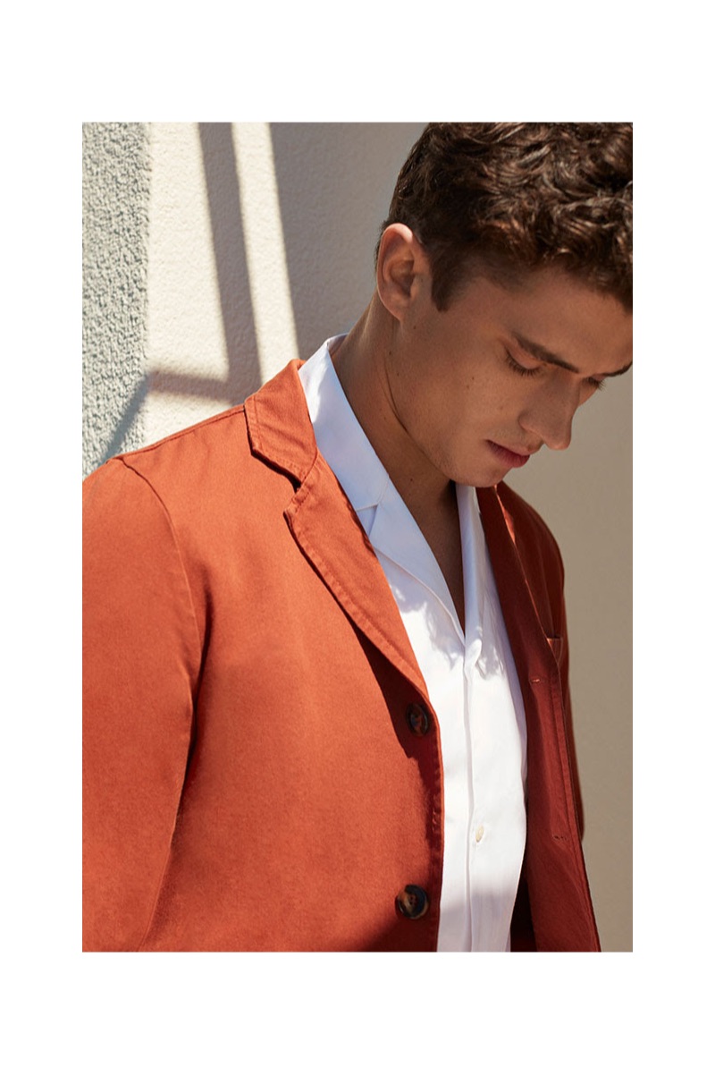 Modeling 8 by YOOX, Matthew Holt wears a white shirt $95 and rust colored blazer $79.