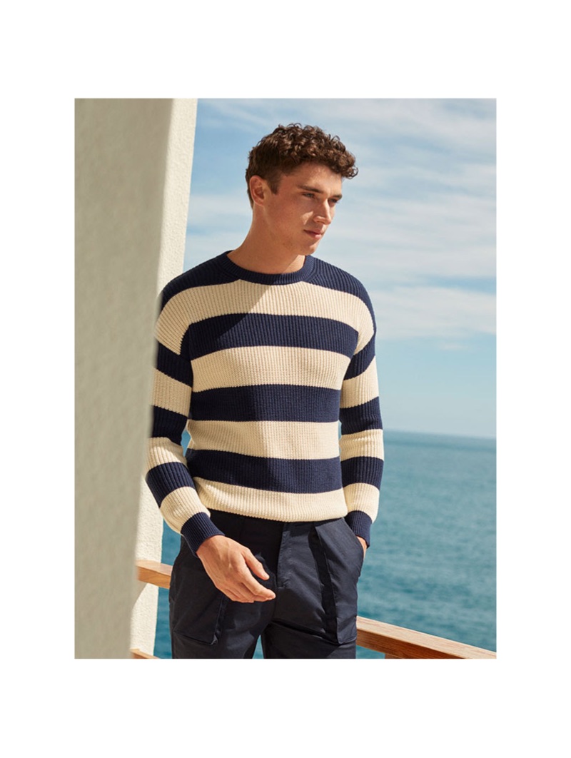 A summer vision, Matthew Holt dons a 8 by YOOX striped sweater $89 and Bermuda shorts $59.