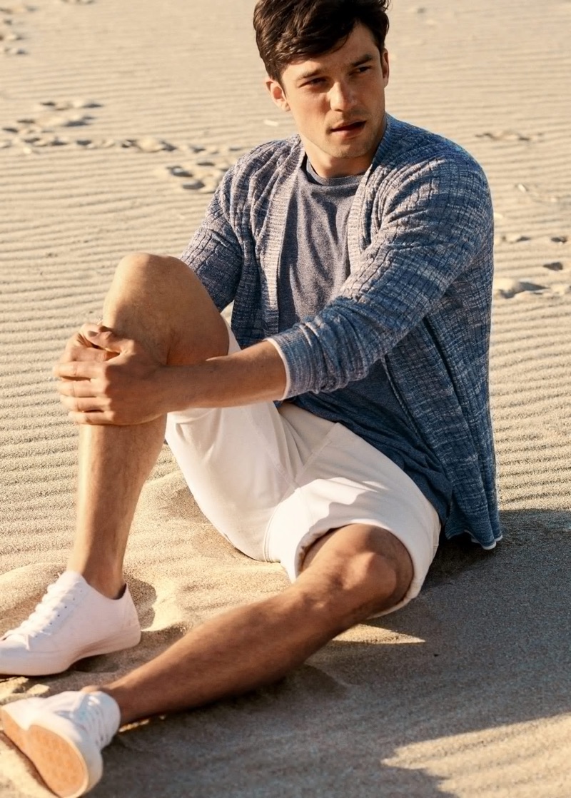 Taking to the beach, Alexis Petit rocks a ribbed cardigan with a tee and shorts from Mango.