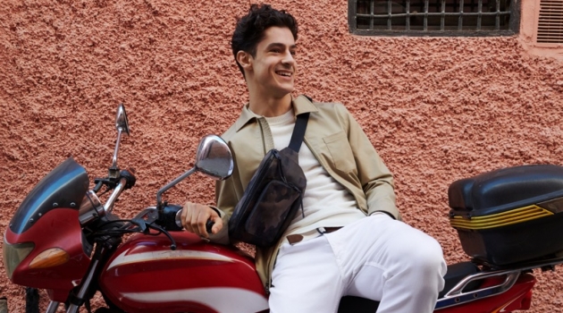 Banana Republic Travels to Marrakech for Summer '19 Outing All smiles, Cyrus Amini wears Banana Republic's Core Temp coach's jacket $149, chinos $98, suede loafers $148, and a camouflage print belt bag $59.50.