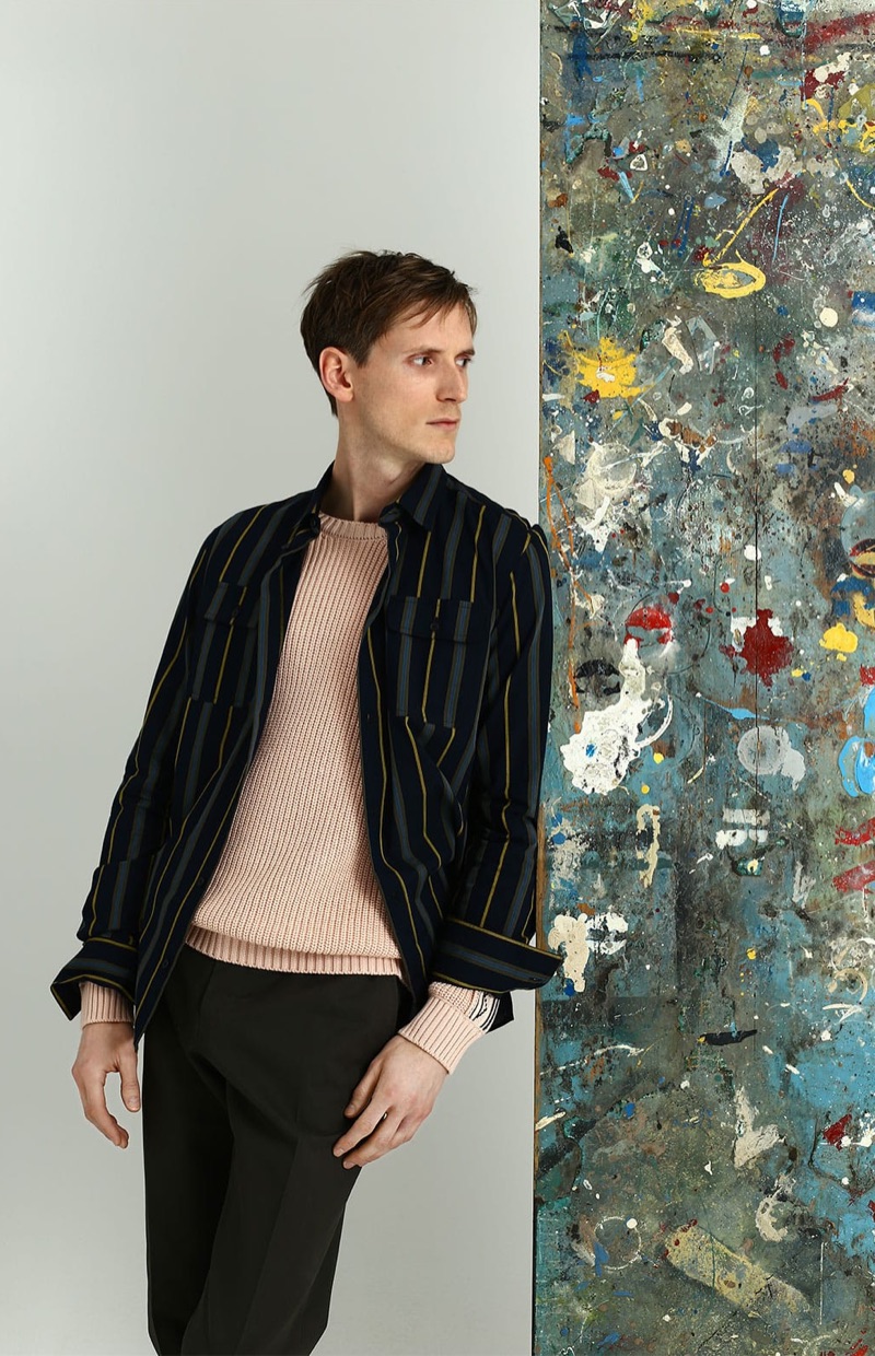 Donning a striped Bottega Veneta shirt, Bastiaan Ninaber also wears an Alanui sweater and Fendi trousers.