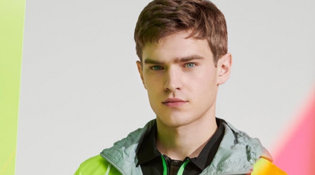 Next Level Neon: Bo Develius Dons Bold Looks for YOOX Going retro, Bo Develius sports a Balenciaga jacket.