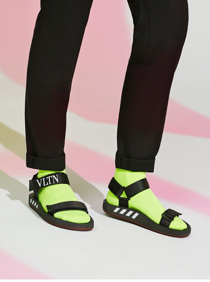 A fashion statement arrives in the form of Valentino logo sandals.