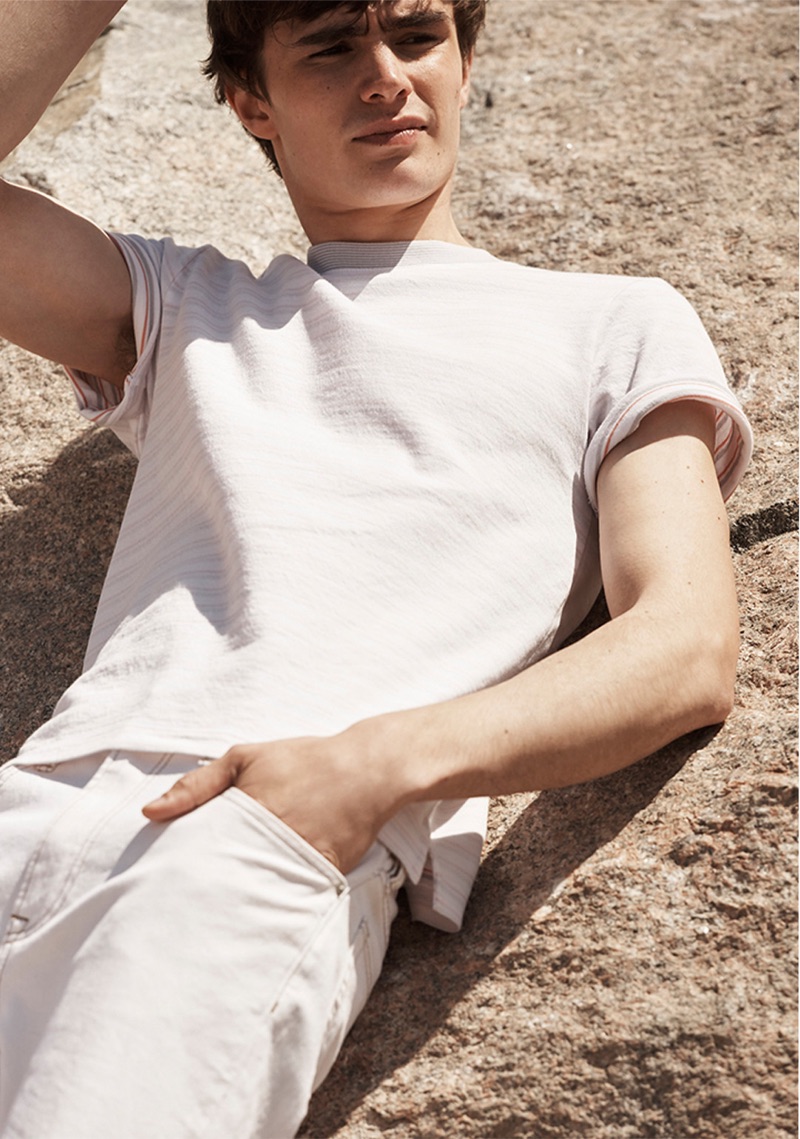 Laying out, Liam Little rocks a Club Monaco multi-stripe tee $59.50 and cropped straight jeans $129.50.