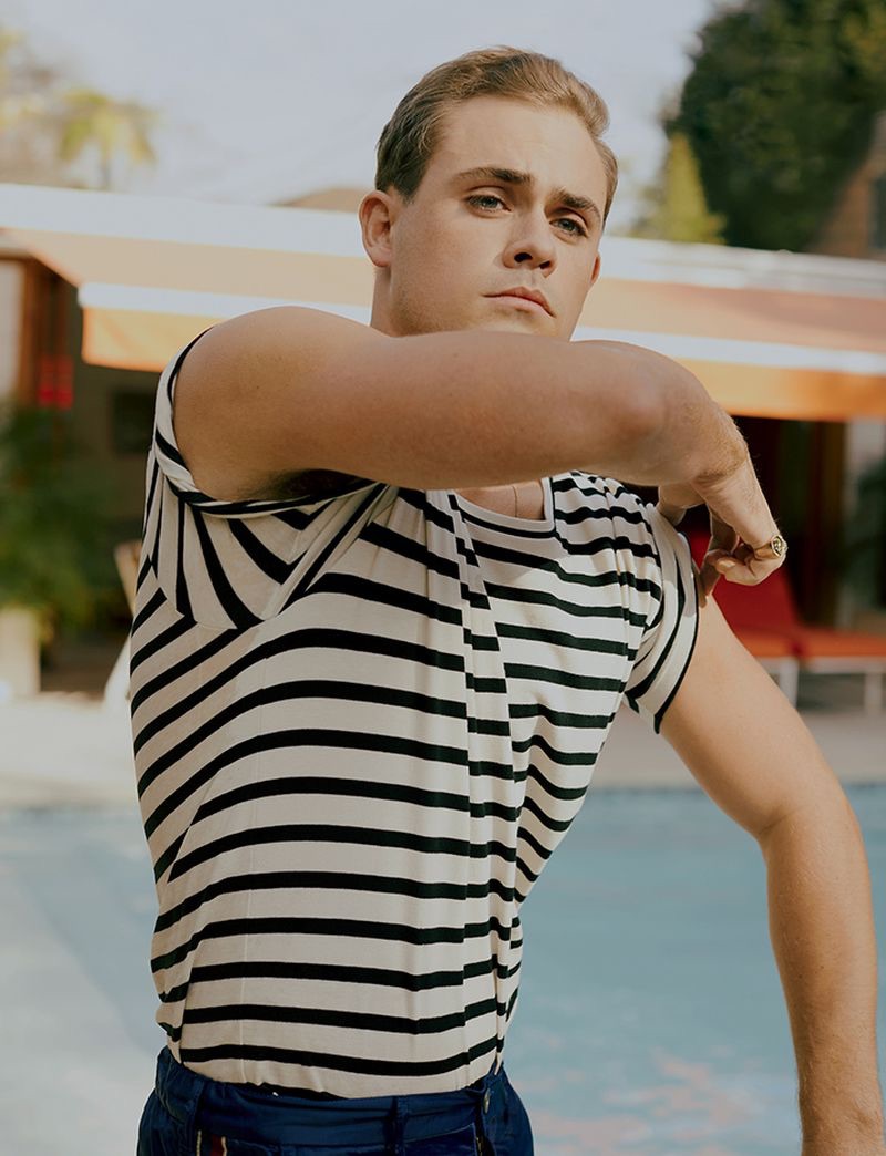 Actor Dacre Montgomery wears a striped t-shirt and pants by Gucci. 