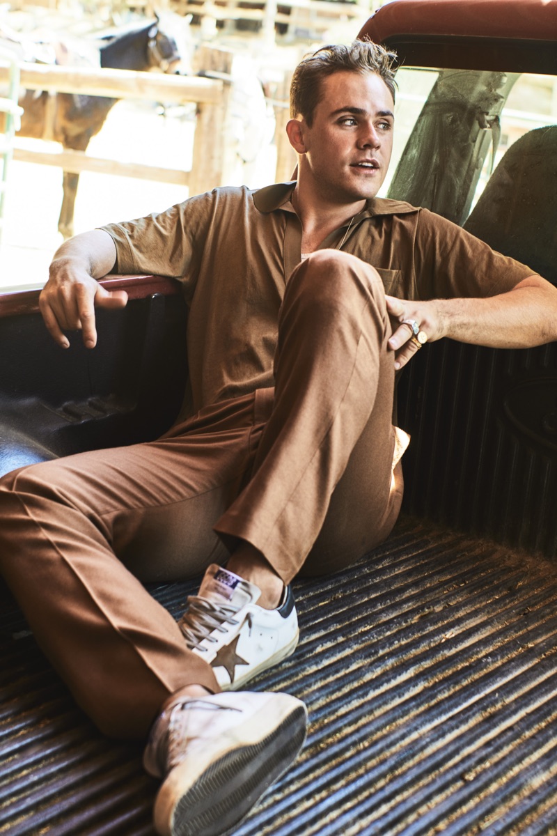 Embracing brown, Dacre Montgomery dons a Dries Van Noten polo, Billy tank, Camoshita trousers, and Golden Goose sneakers.