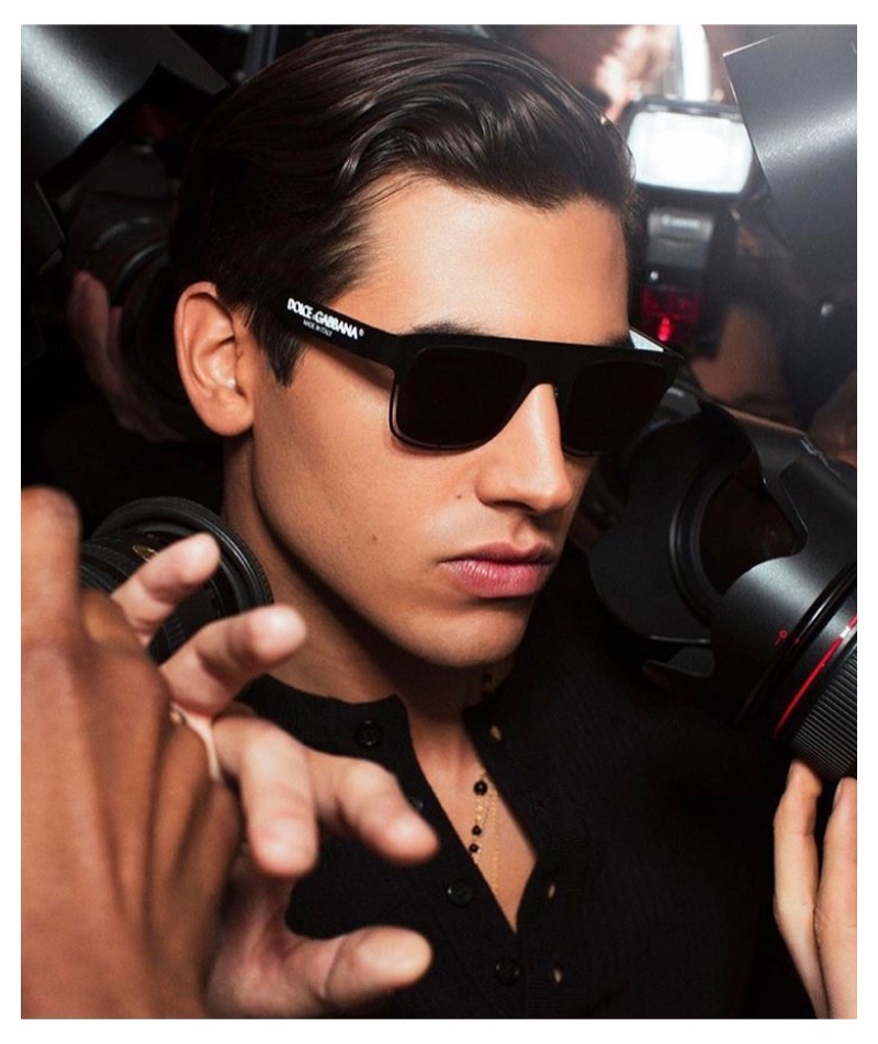 Surrounded by photographers, model Marco Bellotti fronts Dolce & Gabbana's new eyewear campaign.