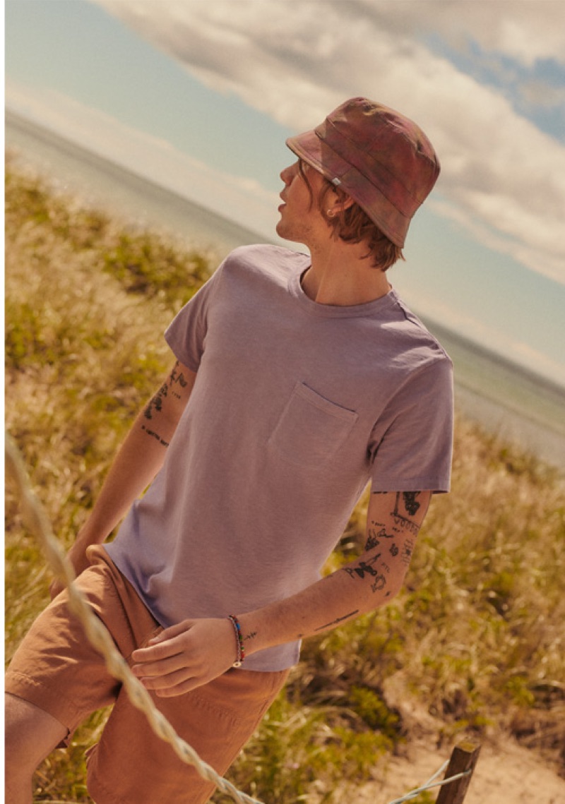 A summer vision, Luca Bertea models a J.Crew garment dye pocket t-shirt, Billy Reid linen shorts, and a New Era bucket hat.