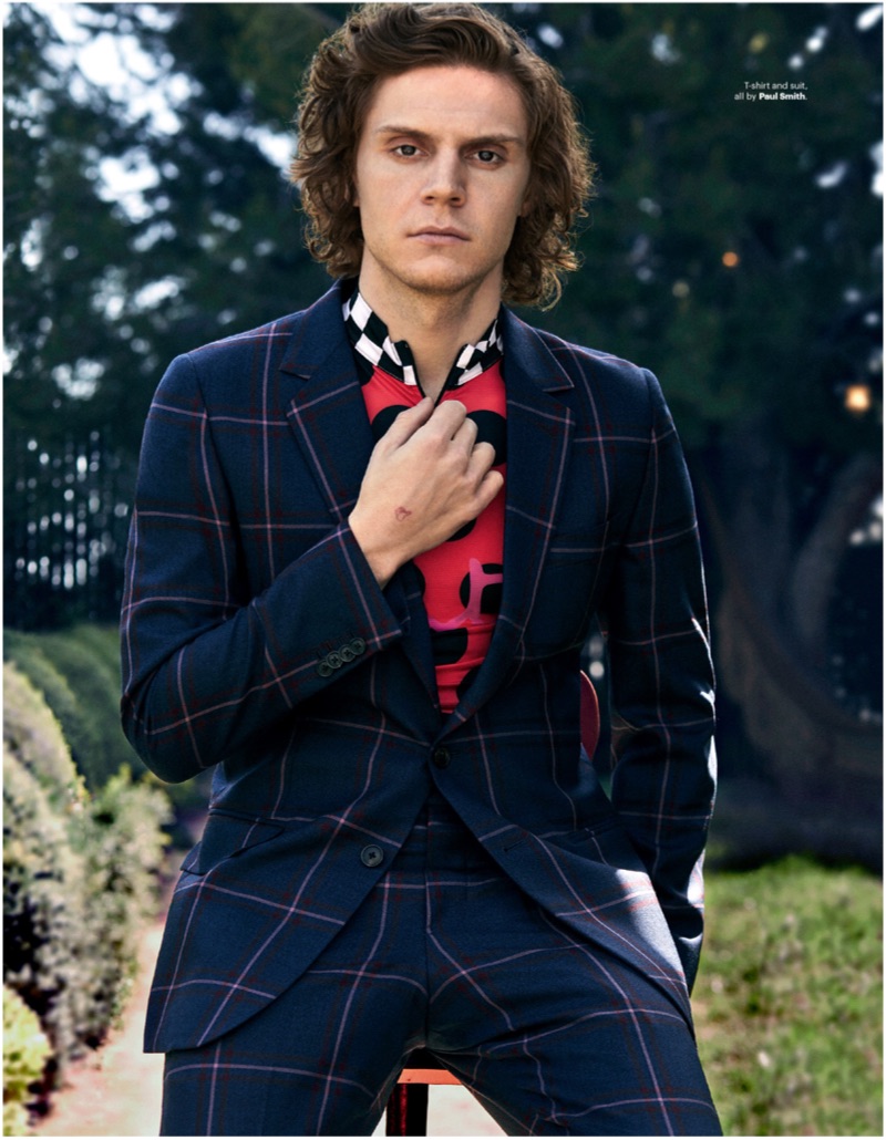 Donning a windowpane print suit, Evan Peters wears Paul Smith.