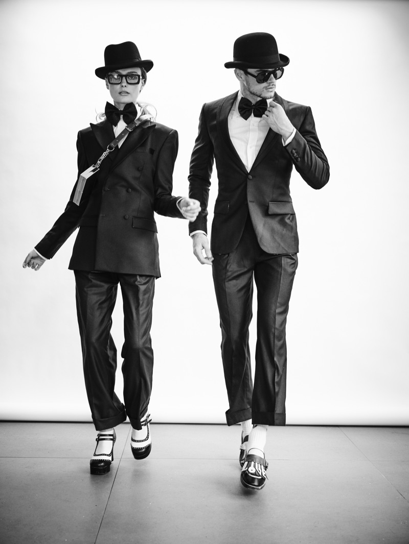 Going incognito, Erin Heart and Christian Williams don smart suiting numbers by Helen Anthony with Laird Hatters hats and glasses by Delirious Eyewear.