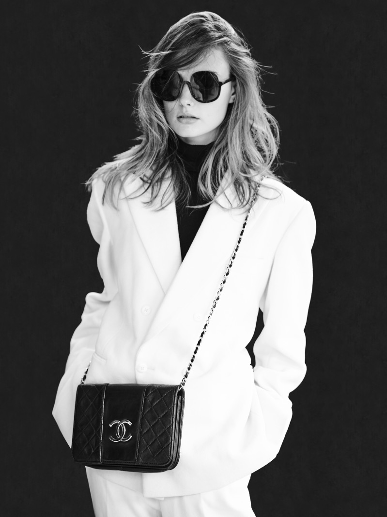 Chic in white, Erin Heart models a tailored look by Helen Anthony. She also wears a Chanel bag and Delirious Eyewear sunglasses. 